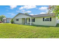 Charming single-story home with a well-manicured lawn, inviting front porch and side-entry garage at 934 Point View Ln, Lakeland, FL 33813