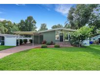 Charming single-story home featuring a well-manicured lawn and covered carport at 941 Avon Ave, Lakeland, FL 33801
