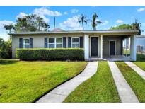 Charming single-story home with a well-manicured lawn and covered parking space at 124 Carolyn Dr, Lakeland, FL 33803