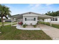 Charming single-story home with a carport and a well-maintained front lawn, perfect for relaxed outdoor living at 1823 Blue Lake Dr, Lakeland, FL 33801