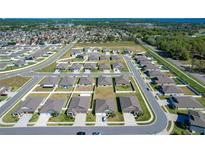 Expansive aerial view of a suburban neighborhood with well-maintained homes and green spaces in a planned community at 2929 Flying Blackbird Rd, Bartow, FL 33830