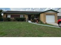 Cozy one-story home with a well-maintained lawn and an attached single-car garage at 322 Ne 9Th St, Mulberry, FL 33860