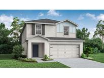 Charming two-story home with gray shingles, white siding, and manicured landscaping at 5317 Se 127Th Ln, Belleview, FL 34420