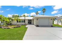 Charming single-story home featuring a well-manicured lawn, inviting entrance, and a convenient attached garage at 6 Rosewood Dr, Davenport, FL 33837