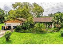 Charming single-story home with mature trees and lush landscaping in a desirable neighborhood at 6134 Christina E Dr, Lakeland, FL 33813