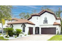 Charming two-story home featuring a terracotta roof, beautiful landscaping, and a three-car garage at 11761 Bella Milano Ct, Windermere, FL 34786
