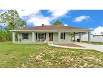 Charming single-story home featuring a welcoming front porch and covered carport at 13522 Rockridge Rd, Lakeland, FL 33809