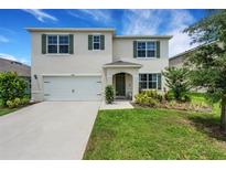Charming two-story home with a well-manicured lawn and attached two car garage at 3685 Diving Dove Ln, Bartow, FL 33830
