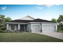 Charming single-story home with a well-manicured lawn and a two-car garage on a sunny day at 561 Silver Course Run, Ocala, FL 34472