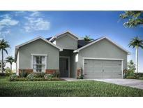 Charming single-story home with a gray facade, attached two-car garage, and well-manicured lawn at 569 Silver Course Radl, Ocala, FL 34472