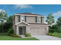 Charming two-story home with gray siding, green shutters, and an attached two-car garage at 827 Cypress Creek Run, St Cloud, FL 34771