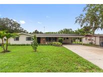 Charming single-story home featuring a well-manicured lawn and covered carport at 848 17Th Ne Ter, Winter Haven, FL 33881