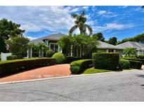 Charming single-story home with lush landscaping, mature trees, and a circular driveway at 943 Hamilton Place Ln, Lakeland, FL 33813