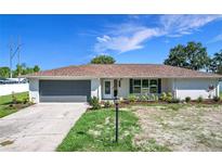 Charming single-story home featuring a well-manicured lawn and inviting curb appeal at 1034 Shadowbrook N Dr, Lakeland, FL 33813