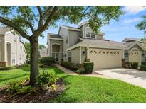 Charming home features a two-car garage, manicured lawn, and mature trees in a well-maintained neighborhood at 1117 Stonebrooke Ln # 58, Lakeland, FL 33803