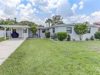 Charming single-story home with manicured lawn and carport, perfect for outdoor living at 1685 Kissengen Ave, Bartow, FL 33830