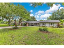 Charming single-story home with a well-maintained lawn and inviting carport entrance at 1715 Lando Ln, Orlando, FL 32806