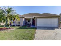 Charming home featuring a well-manicured lawn and a welcoming front porch area with mature landscaping at 244 Kings Pond Ave, Winter Haven, FL 33880