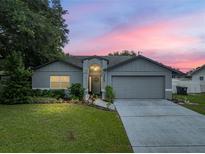 Charming one story home with a well maintained lawn and mature tree in front at 257 Padgett N Pl, Lakeland, FL 33809