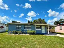 Charming single-story home with a covered carport, a well-maintained lawn and landscaping at 2655 Hempstead Dr, Lakeland, FL 33801
