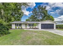 Charming single-story home with a well-maintained lawn, freshly painted exterior, and a two car garage at 2726 Cleveland Heights Blvd, Lakeland, FL 33803
