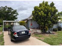 A charming single-story home featuring mature trees and a driveway with parking at 337 Pearl St, Lake Wales, FL 33853