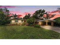 Charming single-story home featuring a well-maintained lawn, carport, and inviting curb appeal at 4219 Forest Hills Dr, Lakeland, FL 33813