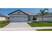 Beautiful one-story home features a two car garage and a well-maintained, landscaped front yard at 5409 Waterside Dr, Auburndale, FL 33823