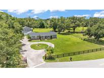 Sprawling property featuring a single story home, a second residence, and a circular driveway at 59 Jimmy Lee Rd, Winter Haven, FL 33880