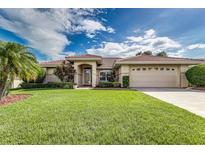 Charming home with a tile roof, manicured lawn and mature landscaping creates great curb appeal at 104 Morning Glory Cir, Winter Haven, FL 33884