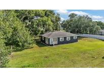 Charming single-story home with a well-maintained yard and mature trees providing ample shade at 1050 Reynolds Rd, Lakeland, FL 33801