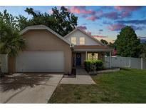 Charming single-Gathering home with a well-manicured lawn, white picket fence and attached two car garage at 114 Ed Padgett Rd, Lakeland, FL 33809