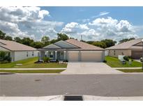 Charming single-story home with a well-manicured lawn and a two-car garage at 2958 Flying Blackbird Rd, Bartow, FL 33830