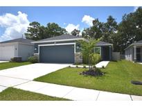Charming single-story home with a well-maintained lawn and attached two car garage at 312 Walnut Ln, Auburndale, FL 33823