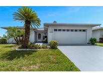 Charming single-story home with a well-maintained lawn, tropical landscaping, and an attached two-car garage at 3783 Wildcat Run, Lakeland, FL 33810