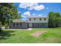 Charming home featuring a mix of brick and vinyl siding, complemented by a well-maintained lawn and mature trees at 4908 S Bedford Ln, Lakeland, FL 33813