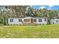 Charming single-story home with a inviting front porch and well-manicured lawn at 4931 Dove Cross Dr, Lakeland, FL 33810