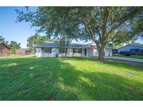 Charming single-story home with a well-maintained lawn and mature shade trees at 6507 Shadowbrook Run, Lakeland, FL 33813