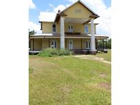 Charming two-story home with metal roof, large columns, and wraparound porch at 701 1St Ne St, Fort Meade, FL 33841