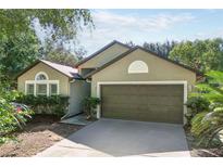 Charming single-story home with a well-manicured lawn, attached garage, and neutral toned exterior at 1125 Blackjack Ridge St, Minneola, FL 34715