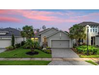 Charming single-story home featuring a paved driveway, well-maintained lawn, and tasteful landscaping at 180 Azure Mist Way, Daytona Beach, FL 32124