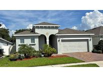 Charming single-story home with a two-car garage, lovely landscaping, and a well-manicured lawn at 2169 Rush Bay Way, Orlando, FL 32824