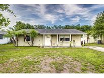 Charming single-story home with a well-maintained lawn and inviting front porch at 2443 Delrose E Dr, Lakeland, FL 33805