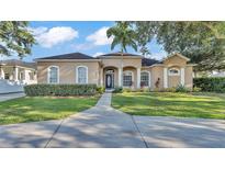 Elegant single-story home featuring manicured landscaping and a welcoming entrance with charming architectural details at 2533 Peterson Rd, Lakeland, FL 33812