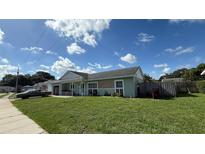 Charming single-story home featuring a covered porch and well-maintained lawn, with a classic car parked on the side at 3100 Abaco St, Orlando, FL 32827