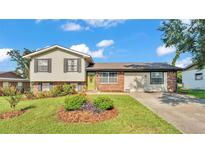 Charming two-story home with a well-manicured lawn and an inviting green front door at 4908 Celia W Cir, Lakeland, FL 33813