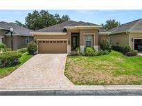 Charming home featuring a brick-paved driveway and meticulously maintained landscaping at 961 Christina Chase Dr, Lakeland, FL 33813