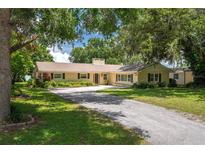 Inviting single story home featuring a long driveway and well maintained lawn at 18 Aqualane Dr, Winter Haven, FL 33880