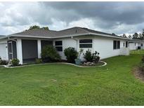 Charming home featuring a well-manicured lawn and a screened-in lanai for outdoor relaxation at 2235 Grand Cypress Dr # 561, Lakeland, FL 33810