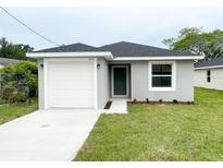 Charming single-story home featuring a one-car garage, green front door, and fresh landscaping at 2517 Sunset Dr, Winter Haven, FL 33881